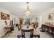 Open-concept living room with dining area, tile floors, and a view of the entryway at 1707 Hibiscus S Cir, Oldsmar, FL 34677