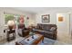 Cozy living room featuring tile flooring, comfortable seating, and ample natural light at 1707 Hibiscus S Cir, Oldsmar, FL 34677