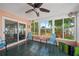 Cozy patio with comfortable seating, ceiling fan, and sliding glass doors at 1707 Hibiscus S Cir, Oldsmar, FL 34677