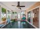 Cozy sunroom featuring tile floors, a ceiling fan, a comfortable hanging chair and lots of natural light at 1707 Hibiscus S Cir, Oldsmar, FL 34677