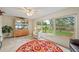 Inviting sunroom with backyard views through expansive windows, filled with sunlight and neutral decor at 1707 Hibiscus S Cir, Oldsmar, FL 34677