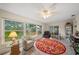 Bright sunroom with large windows overlooking the backyard, features neutral decor and a ceiling fan at 1707 Hibiscus S Cir, Oldsmar, FL 34677