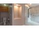 Accessible bathroom with walk-in shower featuring marble tile and handrails at 17508 Isbell Ln, Odessa, FL 33556