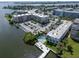 Condominium aerial view featuring waterfront access, a pool, and parking at 1859 Shore S Dr # 202, South Pasadena, FL 33707