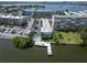 Gorgeous aerial view of the waterfront condo building, pool, boat dock and surrounding neighborhood on a sunny day at 1859 Shore S Dr # 202, South Pasadena, FL 33707