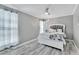 A primary bedroom featuring neutral colors, ceiling fan, and wood flooring at 1859 Shore S Dr # 202, South Pasadena, FL 33707