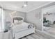A primary bedroom with a ceiling fan, stylish bed frame, and a sitting area at 1859 Shore S Dr # 202, South Pasadena, FL 33707