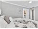 A primary bedroom with a gray color scheme and a view into the bathroom and living spaces at 1859 Shore S Dr # 202, South Pasadena, FL 33707