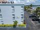 Exterior view of a building with well maintained landscape and a sign that reads CASA PRIMA 1659 at 1859 Shore S Dr # 202, South Pasadena, FL 33707