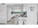 Bright kitchen features white cabinets, modern appliances, and breakfast bar with seating at 1859 Shore S Dr # 202, South Pasadena, FL 33707