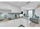 Updated kitchen with bar seating open to the living room area at 1859 Shore S Dr # 202, South Pasadena, FL 33707