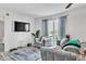 Well-lit living room features plush gray sofas, a large window and an entertainment center at 1859 Shore S Dr # 202, South Pasadena, FL 33707
