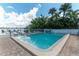Inviting pool area with lounge chairs surrounded by lush tropical landscaping at 1859 Shore S Dr # 202, South Pasadena, FL 33707
