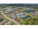 Expansive aerial perspective of the community, featuring multiple lakes, amenities, and residential areas at 19183 Coastal Shore Ter, Land O Lakes, FL 34638