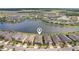 Aerial view of a home near a serene lake with other houses in the community at 19183 Coastal Shore Ter, Land O Lakes, FL 34638