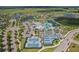 Stunning aerial view showcasing the community's layout, pools, tennis courts, and surrounding lakes at 19183 Coastal Shore Ter, Land O Lakes, FL 34638