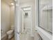Bathroom featuring a toilet, walk-in shower and view of closet with metal shelving at 19183 Coastal Shore Ter, Land O Lakes, FL 34638