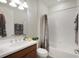Modern bathroom featuring a shower/tub combination and neutral marble-look curtain at 19183 Coastal Shore Ter, Land O Lakes, FL 34638