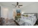 Well-lit bedroom with ensuite bathroom access, ceiling fan, and views of the ensuite bathroom at 19183 Coastal Shore Ter, Land O Lakes, FL 34638