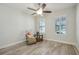 Cozy bedroom with natural light, wood-look floors, and a relaxing reading nook at 19183 Coastal Shore Ter, Land O Lakes, FL 34638