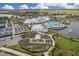 Aerial view of the luxurious clubhouse, pools, and gardens, creating a resort-style living experience at 19183 Coastal Shore Ter, Land O Lakes, FL 34638