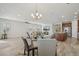 Open floor plan showcasing the dining area, kitchen, and living room, ideal for entertaining guests at 19183 Coastal Shore Ter, Land O Lakes, FL 34638