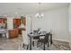 Elegant dining area adjacent to the kitchen, featuring a stylish table setting and modern lighting at 19183 Coastal Shore Ter, Land O Lakes, FL 34638