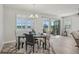 Cozy dining space with views of the backyard, featuring a modern table setting and natural light at 19183 Coastal Shore Ter, Land O Lakes, FL 34638