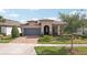 Charming single-story home with a well-manicured lawn and inviting front entrance at 19183 Coastal Shore Ter, Land O Lakes, FL 34638