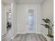 Inviting foyer with decorative front door and stylish gray flooring at 19183 Coastal Shore Ter, Land O Lakes, FL 34638