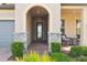 Inviting front porch with stone accents and manicured landscaping at 19183 Coastal Shore Ter, Land O Lakes, FL 34638