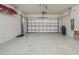 Clean garage with epoxy flooring and storage shelves at 19183 Coastal Shore Ter, Land O Lakes, FL 34638