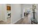 Hallway leading to dining and kitchen area with a laundry area on the left at 19183 Coastal Shore Ter, Land O Lakes, FL 34638