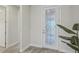 Bright hallway with a decorative front door, plant, and access to other rooms at 19183 Coastal Shore Ter, Land O Lakes, FL 34638