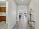 Hallway with stylish flooring leading to an open-concept living area and kitchen at 19183 Coastal Shore Ter, Land O Lakes, FL 34638