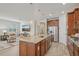Stylish kitchen island with seating, stainless steel appliances, and open view to the living area at 19183 Coastal Shore Ter, Land O Lakes, FL 34638