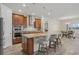 Modern kitchen with a large island, stainless steel appliances, and seamless transition to dining space at 19183 Coastal Shore Ter, Land O Lakes, FL 34638