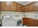 Functional laundry area featuring modern appliances, counter space, and plenty of storage cabinets at 19183 Coastal Shore Ter, Land O Lakes, FL 34638