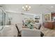 Open-concept living area featuring wood flooring, modern lighting, and ample space for entertaining at 19183 Coastal Shore Ter, Land O Lakes, FL 34638