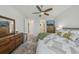 Comfortable main bedroom featuring wood floors, a ceiling fan, and a TV at 19183 Coastal Shore Ter, Land O Lakes, FL 34638