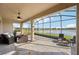 Relaxing screened patio with comfortable seating and scenic views of a serene lake and lush greenery at 19183 Coastal Shore Ter, Land O Lakes, FL 34638