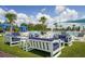 Luxurious community lounge area with pool and modern outdoor furniture provides a comfortable space for relaxation and socialization at 19183 Coastal Shore Ter, Land O Lakes, FL 34638