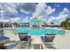 Beautiful community pool with ample lounge seating, shade, and pristine water for residents to enjoy on sunny days at 19183 Coastal Shore Ter, Land O Lakes, FL 34638