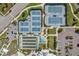 Aerial view of community tennis courts, bocce ball, and garden offering recreational amenities at 19183 Coastal Shore Ter, Land O Lakes, FL 34638