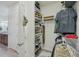 Organized walk-in closet with metal shelving, adjacent to the bathroom at 19183 Coastal Shore Ter, Land O Lakes, FL 34638