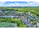 Aerial view of a neighborhood with lush greenery and a peaceful lake at 20106 Bending Creek Pl, Tampa, FL 33647