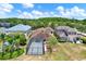 Aerial view of a backyard featuring a screened-in patio and lush landscaping at 20106 Bending Creek Pl, Tampa, FL 33647