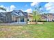 Backyard featuring lush green grass, a screened-in pool, and exterior of the home at 20106 Bending Creek Pl, Tampa, FL 33647