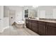Elegant bathroom with a soaking tub, a tiled shower, and granite countertop with and sinks at 20106 Bending Creek Pl, Tampa, FL 33647
