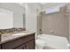 Bathroom with a granite countertop vanity and shower-tub combination with tiled surround at 20106 Bending Creek Pl, Tampa, FL 33647